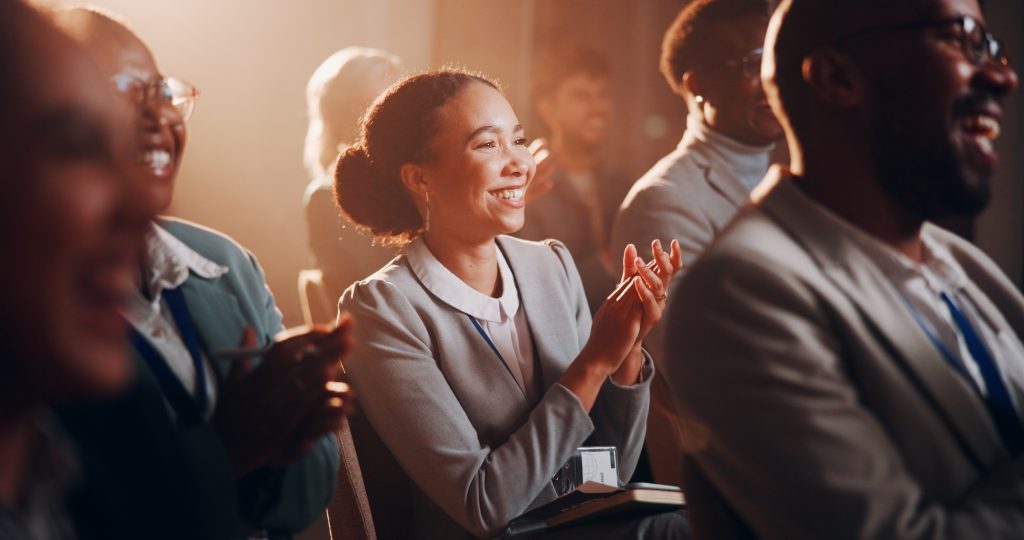 Woman, happy or crowd applause at presentation for business, employee engagement or positive feedba